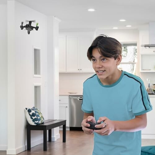 Boy controlling a small drone inside a house.