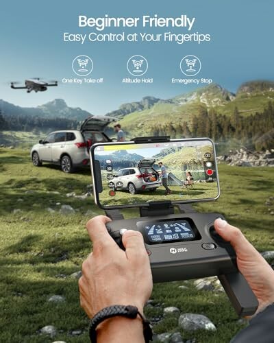 Person holding drone controller with smartphone display, cars and drone in mountain landscape.
