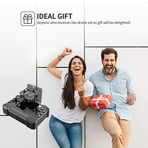 Happy couple with gift box and drone controller.