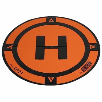 Orange and black drone landing pad with compass markings.