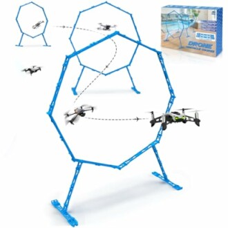 Drone flying through blue octagonal obstacle course hoops with packaging box.
