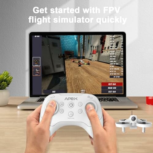 Hands holding a controller in front of a laptop displaying an FPV flight simulator.