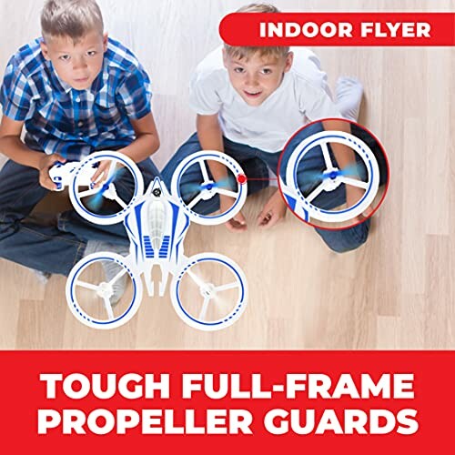 Two kids playing with a drone on a wooden floor, labeled 'Indoor Flyer' and 'Tough Full-Frame Propeller Guards'.