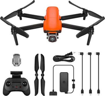 Orange drone with accessories including controller, propellers, and cables.