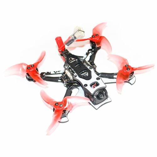 A racing drone with red propellers and a camera.