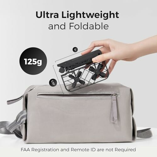 Hand placing foldable drone into gray bag